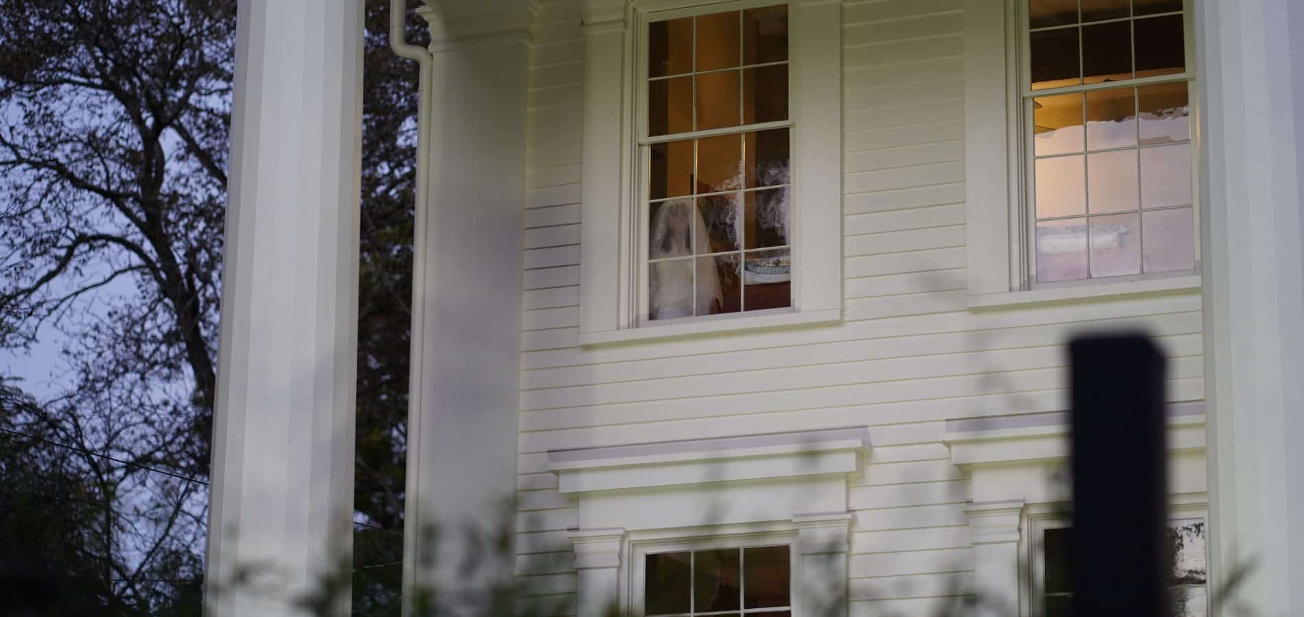 Sylvia gazing from the top floor of Panola Hall